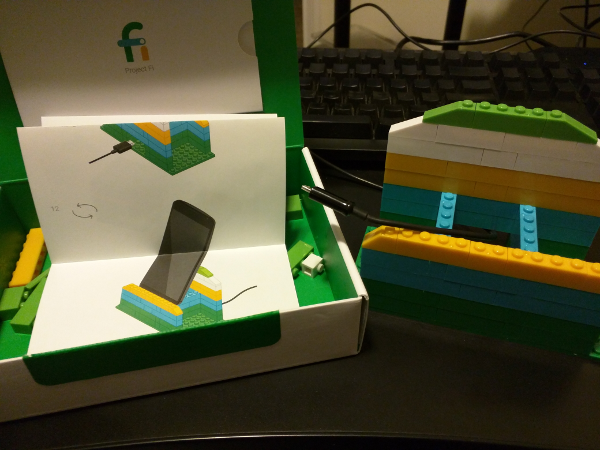 Assembled phone holder and open Project Fi box with instruction booklet in the lid.